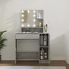 A vanity table with a mirror and lights, decorated with various cosmetic products. Náhled obrázku produktu