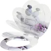 A toilet seat with a decorative design of stacked stones and purple flowers. Produktbild-Vorschau