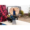 A person in a red plaid shirt is using a log splitter to split a log. Produktbild-Vorschau
