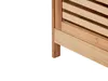 A close-up view of the bottom corner of a wooden cabinet with slatted doors. Náhled obrázku produktu