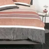 A close-up view of a striped duvet cover and pillow on a bed. Produktbild-Vorschau
