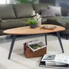A living room scene with a green sectional sofa and a wooden coffee table. Voir les images du produit