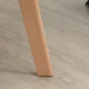 A close-up of a wooden chair leg on a wooden floor. Podgląd zdjęcia produktu