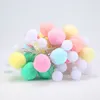 A pile of colorful pom-pom string lights on a white background. Produktbild-Vorschau