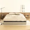 A bed frame with a mattress and bedding in a bedroom setting. Voir les images du produit