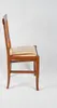 A side view of a chair with a striped seat. Voir les images du produit
