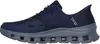 A side view of a navy blue Skechers slip-on shoe with a gray sole. Voir les images du produit