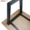 Close-up of black metal table legs attached to a wooden tabletop. Produktbild-Vorschau
