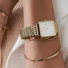 Close-up of a woman's arm wearing a gold watch and bracelets. Podgląd zdjęcia produktu