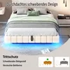 A bed with LED lighting underneath, shown in a bedroom setting with bedside tables and a desk. Náhľad obrázku produktu