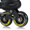 A close-up view of the wheels and frame of a pair of inline skates. Voir les images du produit