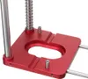 A close-up view of a red and silver woodworking drill guide locator. Náhled obrázku produktu