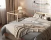A baby crib attached to a bed in a bedroom. Anteprima dell’immagine prodotto