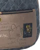 Close-up of a backpack with decorative stitching and metallic accents. Voir les images du produit