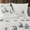 A close-up view of bedding with a penguin print. Produktbild-Vorschau