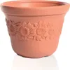 A terracotta flower pot with a sunflower relief pattern. Náhľad obrázku produktu