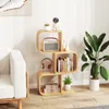 A modern living room with a white sofa and a wooden S-shaped bookshelf filled with decorative items and books. Podgląd zdjęcia produktu