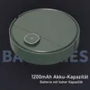 A top-down view of a green robot vacuum cleaner with a silver power button on a dark gray background. Produktbild-Vorschau