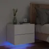 A bedside table with a plant and books next to a bed. Produktbild-Vorschau