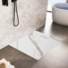 A modern bathroom with a shower tray, bathtub, and patterned wallpaper. Náhled obrázku produktu