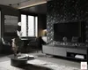 A modern living room with a TV, entertainment center, coffee table, and dining area. Produktbild-Vorschau