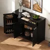 A black sideboard cabinet with its doors and drawer open, displaying various items inside, set against a light-colored wall and wooden floor. Anteprima dell’immagine prodotto