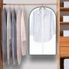 A wardrobe rack with several garment bags and one open garment bag displaying a white shirt. Produktbild-Vorschau