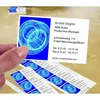 A hand holding a business card with a blue graphic, with several other business cards laid out below it. Anteprima dell’immagine prodotto
