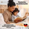 A mother and child are reading a book in bed, surrounded by fairy lights. Produktbild-Vorschau