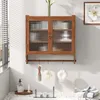 A bathroom vanity area with a wall-mounted cabinet above a sink, featuring bath accessories. Produktbild-Vorschau