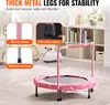 A pink children's trampoline with a safety bar is shown in a room with shelves in the background. Produktbild-Vorschau