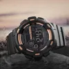 A digital watch is displayed on a rocky surface with water splashing in the background. Podgląd zdjęcia produktu
