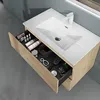 A bathroom vanity with an open drawer displaying various toiletries and accessories. Produktbild-Vorschau