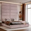 A pink upholstered bed with a large quilted headboard in a bedroom setting. Anteprima dell’immagine prodotto