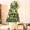 A decorated mini Christmas tree on a table with holiday decorations. Náhľad obrázku produktu