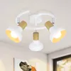 A white ceiling light fixture with three adjustable spotlights, featuring wooden accents. Voir les images du produit