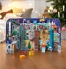 A Christmas advent calendar set up on a wooden floor with a Christmas tree in the background. Voir les images du produit