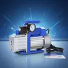 A vacuum pump with a pressure gauge is shown against a blue, abstract background with light streaks. Náhľad obrázku produktu