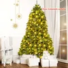 A decorated Christmas tree with presents underneath, in a room with a window and wall decorations. Voir les images du produit