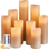 A collection of LED candles of varying heights, arranged together with a remote control in the foreground. Produktbild-Vorschau