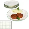 A stack of plates and a plate with food. Náhled obrázku produktu
