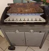 A close-up view of a grill's interior, showing heat shields and burners. Anteprima dell’immagine prodotto