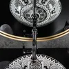 A close-up view of a decorative sink and faucet, reflected in a mirror. Náhled obrázku produktu