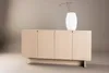 A light wood sideboard with a white vase and decorative branches on top, set against a neutral background. Produktbild-Vorschau