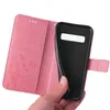 A hand holding a pink floral flip phone case open, revealing the black interior where a phone would be placed. Produktbild-Vorschau
