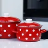 Two red and white polka dot pots with lids on a white surface. Anteprima dell’immagine prodotto