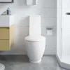 A modern bathroom with a white toilet, wooden vanity, and tiled walls. Náhľad obrázku produktu