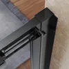 Close-up view of the corner of a black shower door frame, showing the track and mounting mechanism against a marble wall. Produktbild-Vorschau
