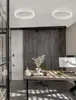 A modern office space with a wooden desk, computer, and decorative items, illuminated by two circular ceiling lights. Produktbild-Vorschau