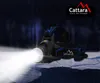 A black and blue Cattara headlamp with its light beam shining brightly, set against a dark, forest-like background. Náhľad obrázku produktu